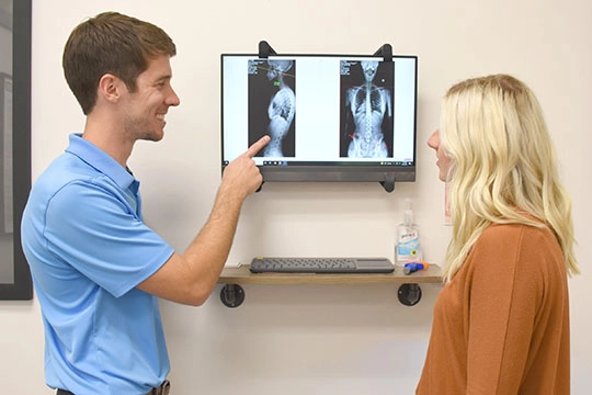 Chiropractor Wauwatosa WI Alexander Young Pointing To Patients XRays