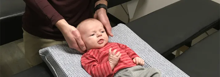 Chiropractor Delafield WI Alexander Young Adjusting Infant Chiropractor Delafield WI Alexander Young Adjusting Infant