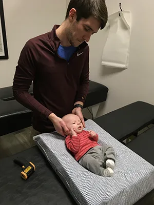 Chiropractor Oak Creek WI Alexander Young Adjusting Infant