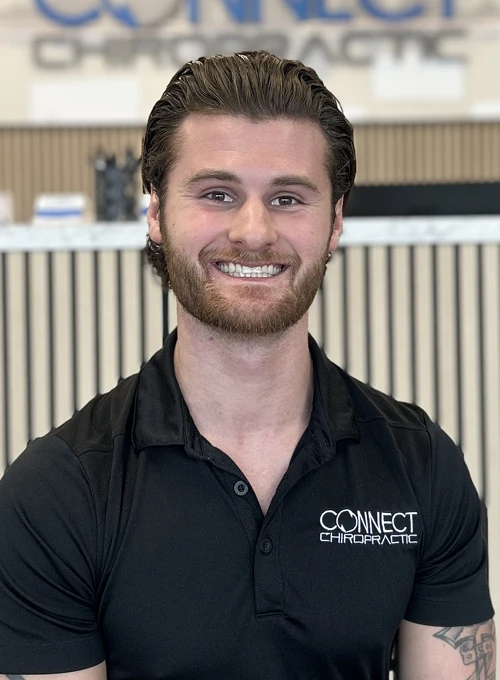 Chiropractor Noah Shulz Smiles Warmly at the Viewer